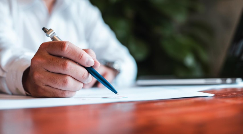 Person carefully reviewing contract before signing