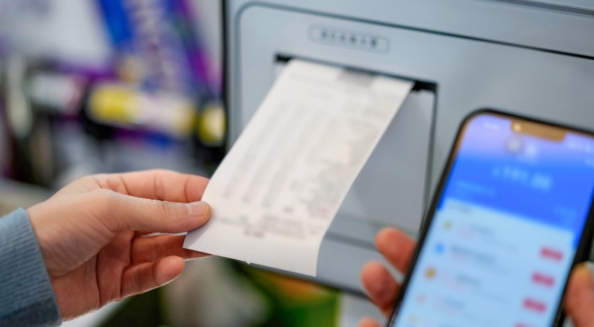 Person using ATM machine outdoors