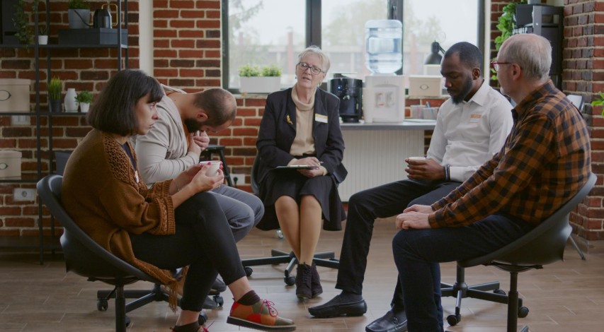 Person attending a supportive recovery group meeting